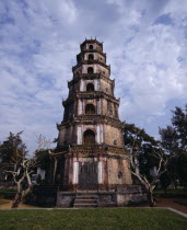 Thien Mu Pagoda tiered brickwork trees & dead trunks mottled sky