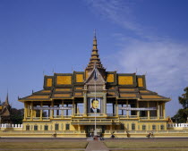 The Royal Palace.  Exterior and entrance gate with passing cyclists.