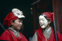 The Autumn Festival with two young boys dressed in red and wearing white masks
