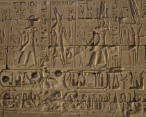 Karnak Temple.  Hieroglyphic details carved in stone wall  people and symbols.