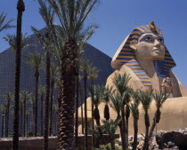 Luxor Hotel and Casino Pyramid shaped building with replica of sphinx beside palm trees