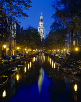 Zuiderkirk and Groenburger canals at night with reflected church and lights.