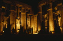 The Temple illuminated at night with giant standing Statues of Rameses II