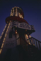 The helter skelter on Brighton Pier illuminated at night