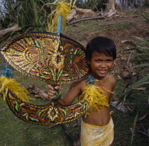 Malay boy holding multicoloured kite