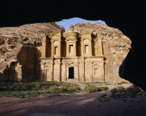 The Monastery carved from rock face framed by rock arch.