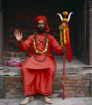 Full length portrait of holy Man dressed in red.