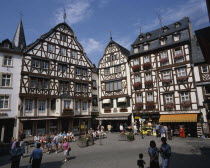 Town square in the Mosel town. Traditional buildings with people and shops