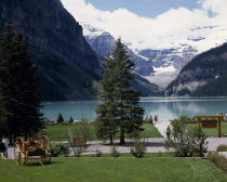 Chateau Lake Louise gardens with the lake and snow capped peaks in the distance