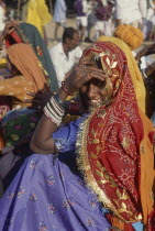 Seated smiling Rajasthani woman in colourful sari
