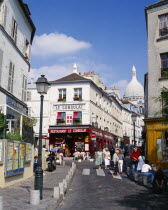 Montmartre.  Restaurant Le Consulat with the Sacre Coeur part seen behind.