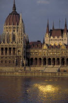 Parliament Building at sunset with the sun reflected from the windows in the river