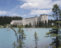 Chateau Lake Louise Hotel with canoeists on the tree lined lake