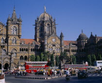 Victoria Terminus railway station with traffic and people outside.