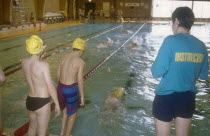 Children at indoor pool with swim instructor