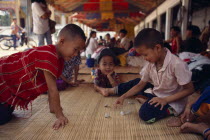 Karen refugee boys playing a game with stones