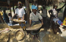 Women winnowing grain.