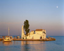 Kanoni  south of Corfu Town.  Vlacherna Monastery.  Boat taking visitors to islet site of seventeenth century monastery.