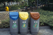 Recycling bins for aluminium cans  plastic bottles and waste paper in Victoria Park on Causeway Bay.