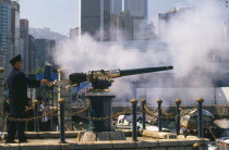 Firing the Noon Day Gun on the Causeway Bay waterfront.