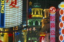 Nanjing Road at night with illuminated neon signs.