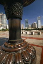 People s Square.  Circular paved area surrounded by skyscrapers with part view of sculpture in the foreground.
