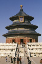 Temple of Heaven.  Hall of Prayer for Good Harvests and Chinese visitors posing for photographs and on steps outside.Peking Beijing