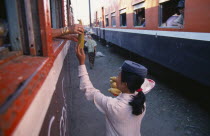 Female vendor selling sweet corn to passengers on the Mandalay to Myitkyina train. Burma