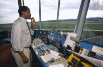 Man using radio in airport control tower in Dar es Salaam airport.
