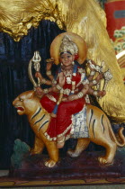 Statue of Durga the inaccessible  a manifestation of Mahadevi emboding Shakti the female principle of the Hindu gods and her vehicle a tiger
