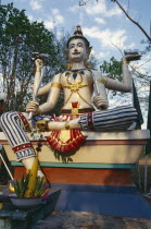 Statue of Siva holding trident conch shell sword and discus