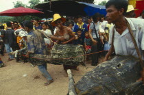 Phi Ta Khon or Spirit Festival. Two men in water buffalo costumes and one man dressed as a woman