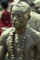 Phi Ta Khon or Spirit Festival. Mud man covered in a thick layer of mud