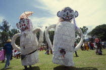 Phi Ta Khon or Spirit Festival. People wearing a pair of male and female big spirits costumes