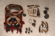 Yao Shamans bag decorated with wild boar tusks and contents of wood  shells  antlers and opium etc.