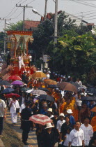 Revered monks funeral procession to cremation grounds with people pulling the funeral carriage