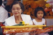 Revered monks funeral with worshippers holding sandalwood  monks robes and flower offerings
