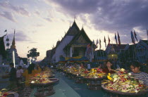 Inthakhin Ceremony. People offering flowers and joss sticks