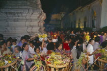 Inthakhin Ceremony. People with offerings of flowers and joss sticks circimambulating