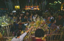 Inthakhin Ceremony. People with offerings of flowers and joss sticks circimambulating