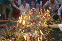 Inthakhin Ceremony. People with offerings of flowers candles and joss sticks