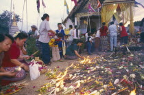 Inthakhin Ceremony. People with offerings of flowers candles and joss sticks
