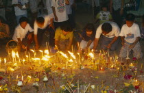 Inthakhin Ceremony. People with offerings of flowers candles and joss sticks