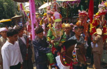 Shan Poi San Long. Crystal Children ceremony with Luk Kaeo in costume riding a pony in parade to Wat Pa Pao