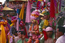 Shan Poi San Long. Crystal Children ceremony with Luk Kaeo in costumes sitting on mens shoulders at Wat Pa Pao