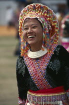 Hmong New Year. Young blue Hmong woman in her New Year finery laughing