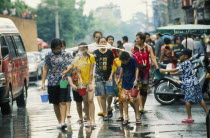 Songkran aka Lunar New Year. Revellers having water thrown at them by a young boy