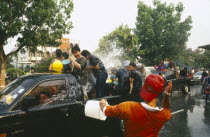 Songkran aka Lunar New Year. Revellers in a pickup truck attempting to catch some of the water thrown at themLorry