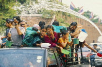 Songkran aka Lunar New Year. Revellers in a pickup truck attempting to catch some of the water thrown at them Lorry