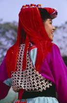 Back view of a young Lisu woman wearing her New Year finery